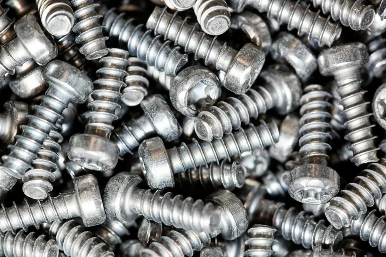 Furniture fasteners and screws grouped for assembly.